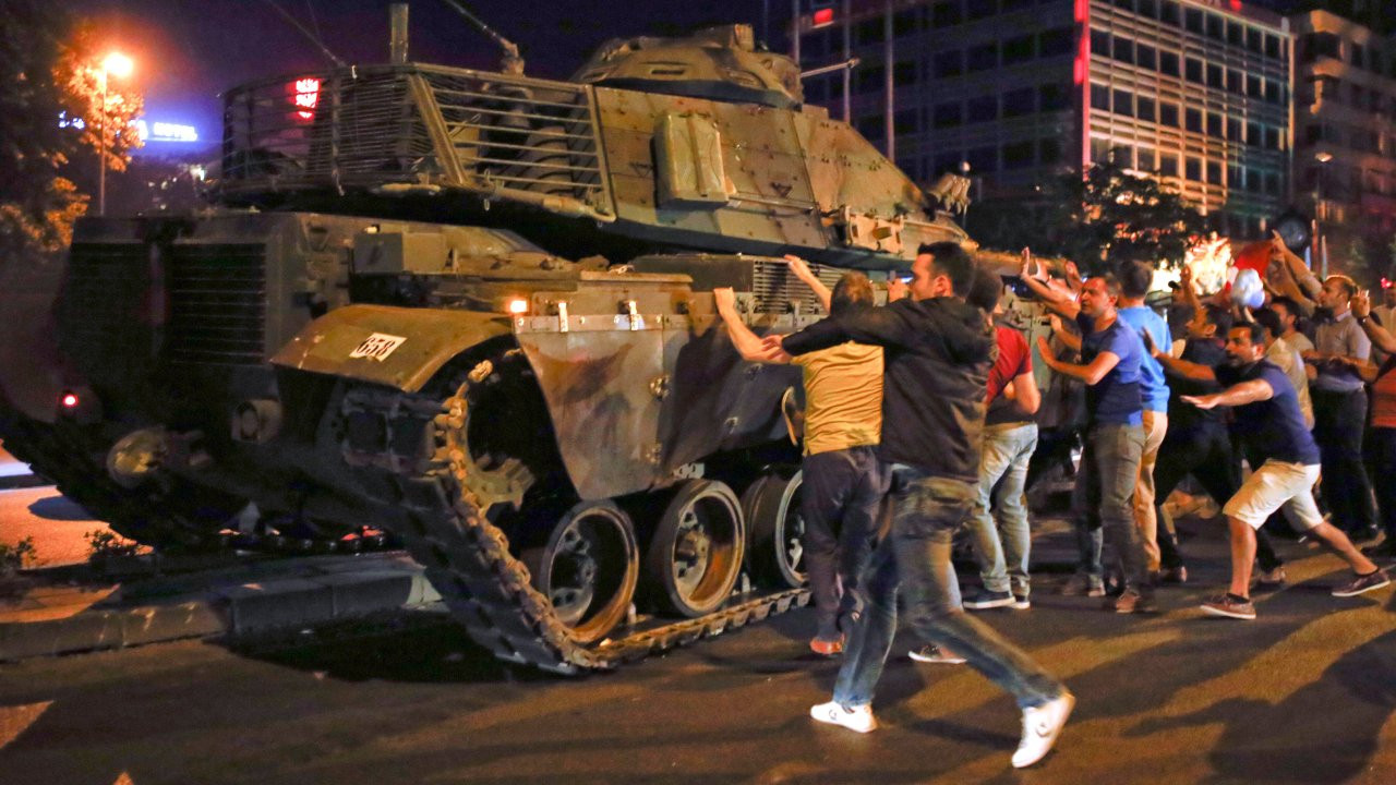 People react near a military vehicle during an attempted coup in Ankara on July 16, 2016.
