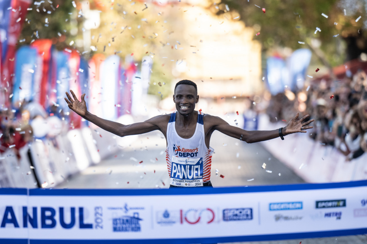 Men's Category winner Panuel Mkungo crosses the finish line.
