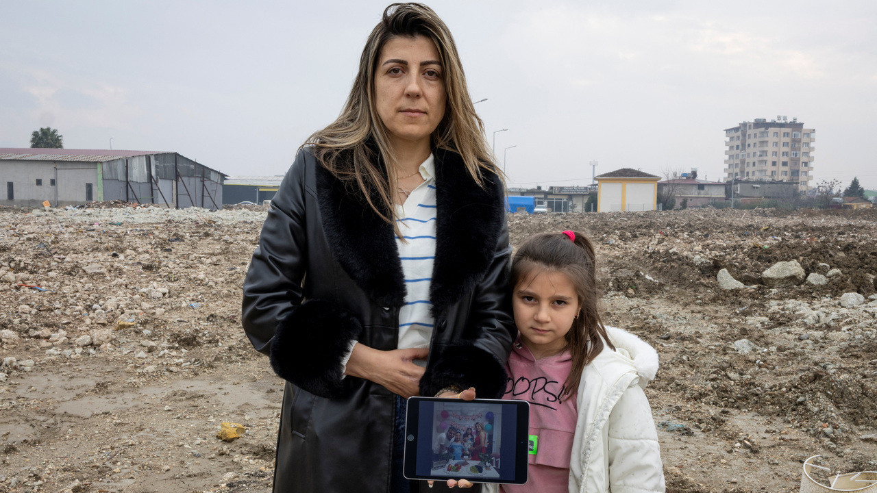 Quake survivors hold photos of dead relatives amidst ruins in Turkey