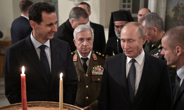 Russia's Putin makes rare visit to Syria, meets Assad